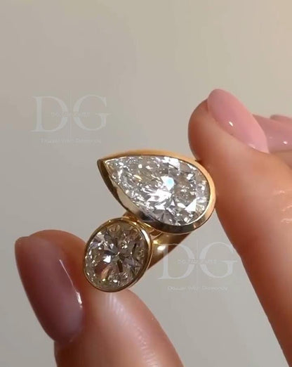 Bezel Set Toi et Moi Engagement Ring: Pear & Oval Lab Grown Diamond